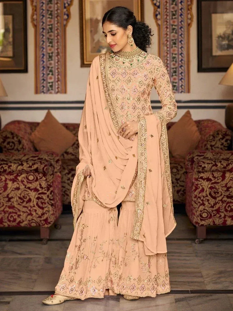 Elegant peach designer salwar kameez with gold embroidery, perfect for Indian ethnic wear occasions