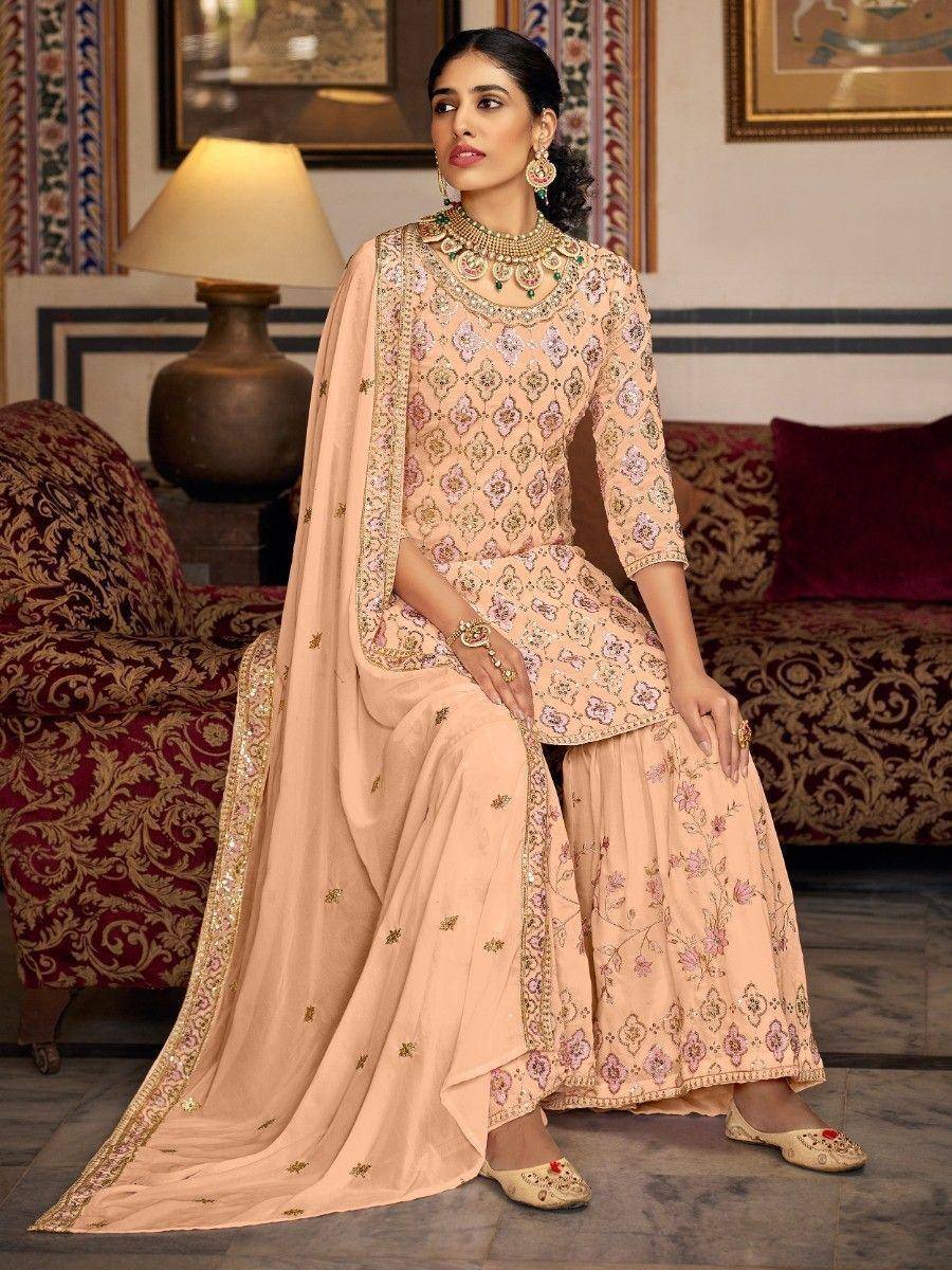 Elegant peach designer salwar kameez with floral embroidery and gold detailing, perfect for ethnic occasions
