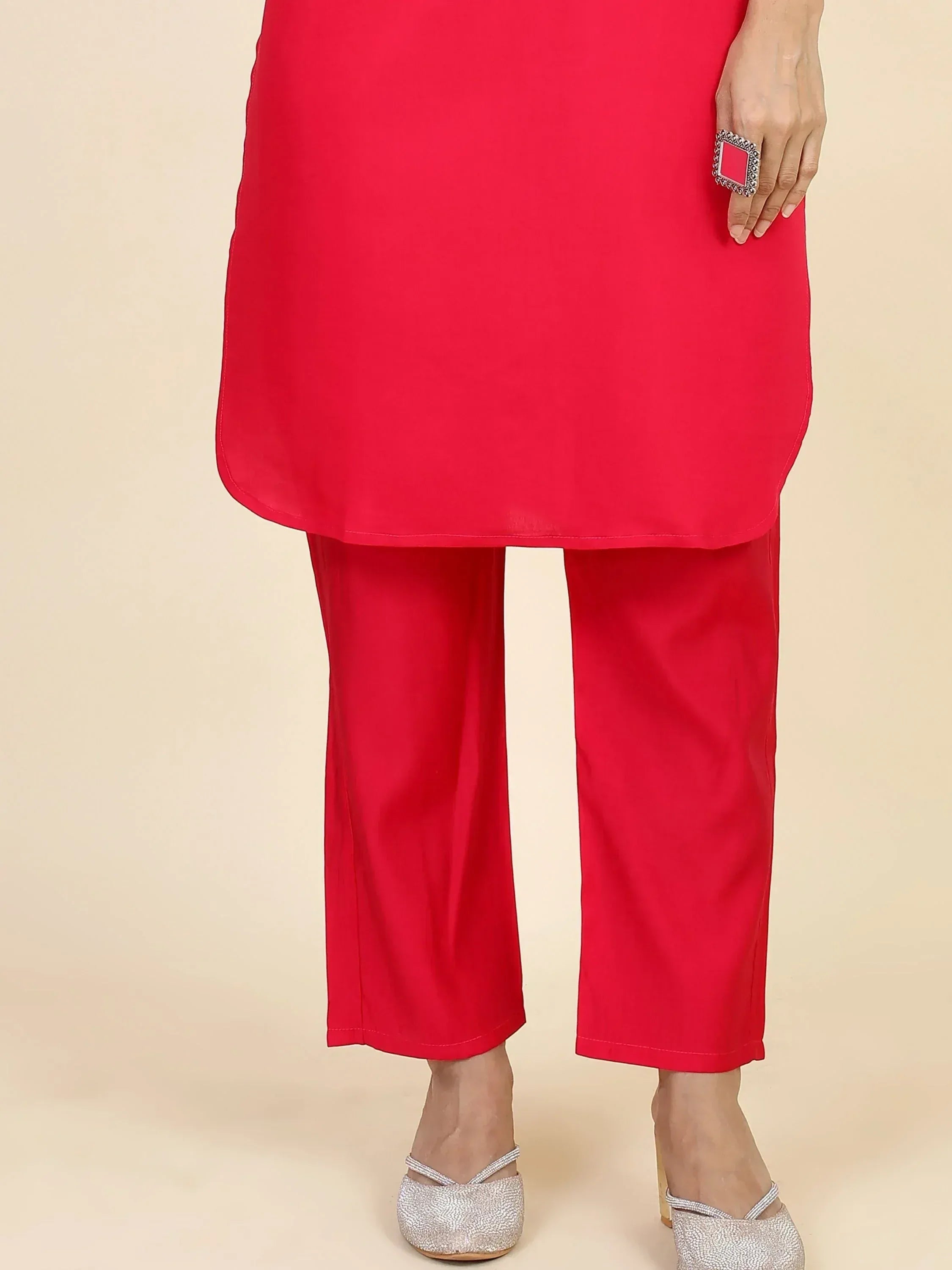 Vibrant red ethnic kurta with matching pants, styled with silver heels and statement ring for festive occasions