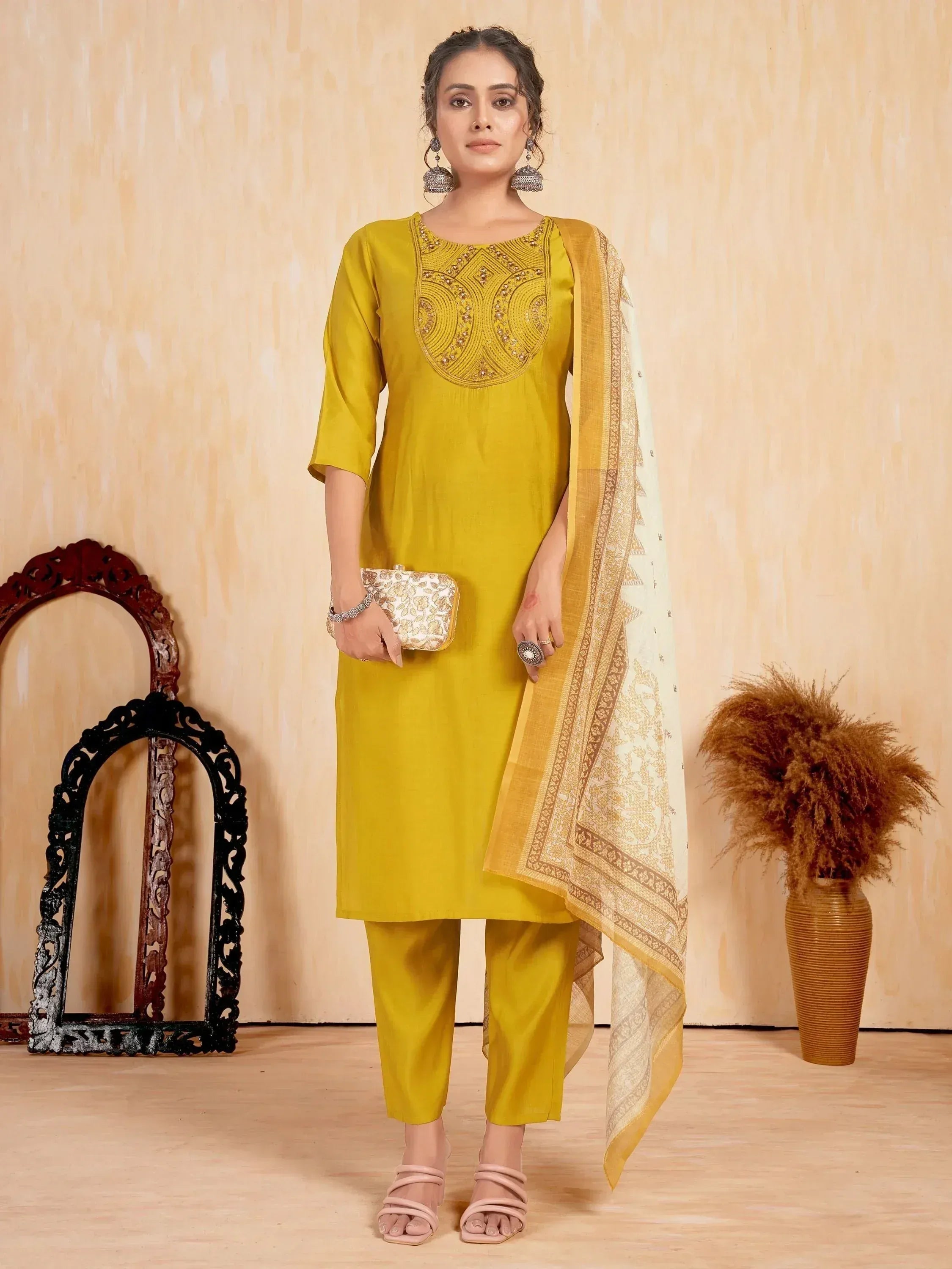 Yellow embroidered kurta with matching pants and dupatta, styled with ethnic accessories