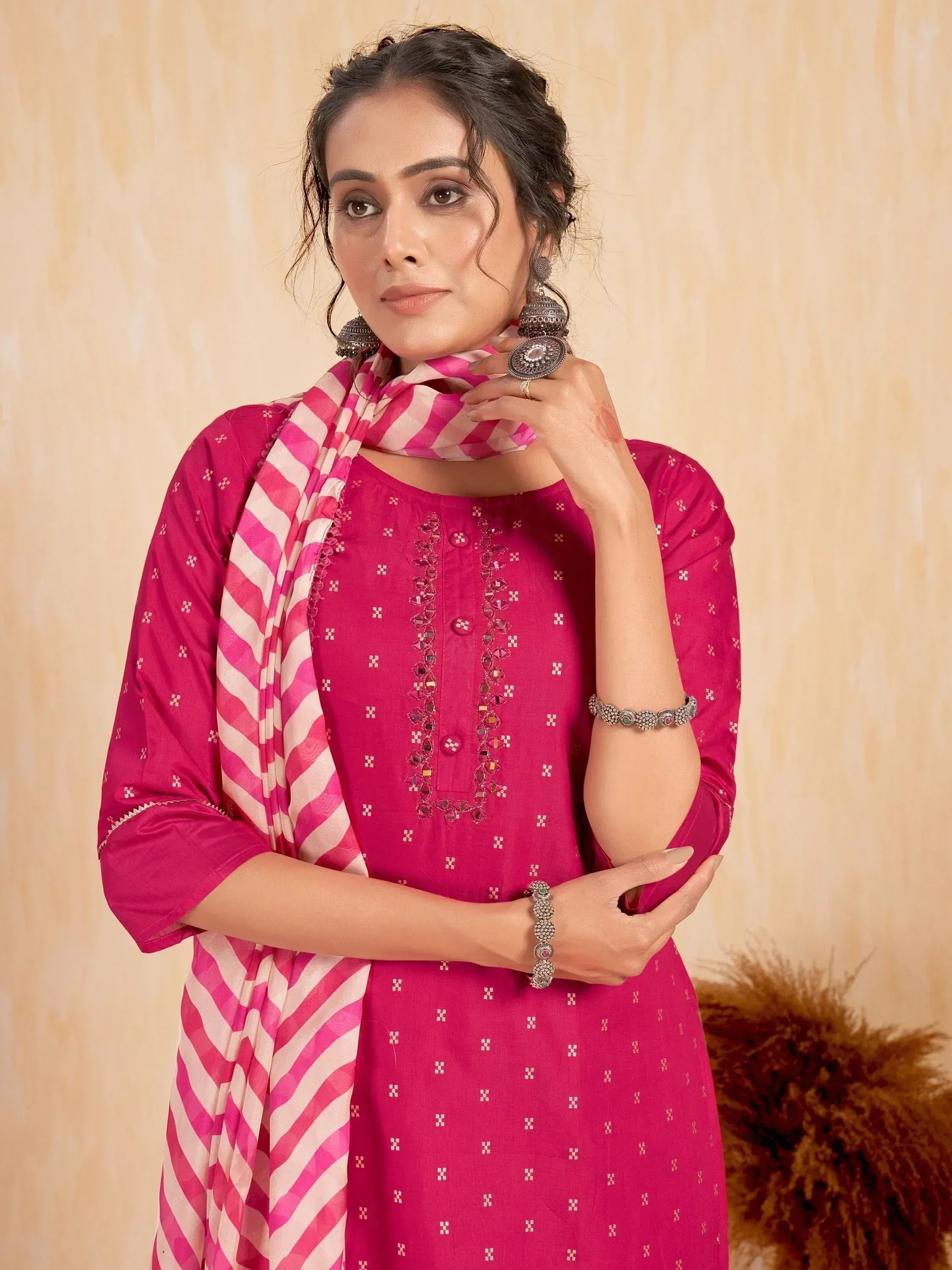 Woman in a pink embroidered kurti with striped pink dupatta and oxidized jewelry
