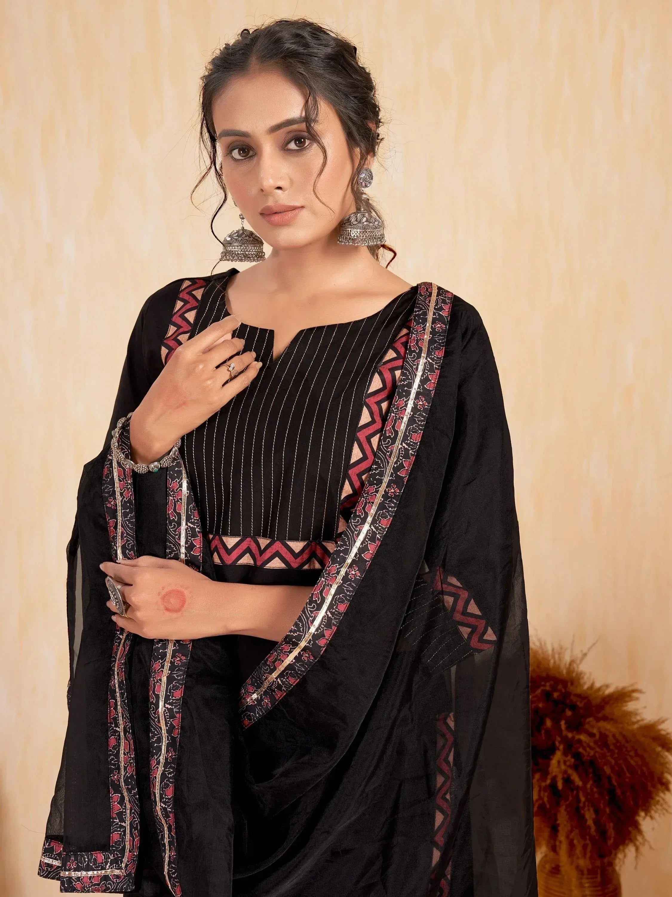 Black ethnic salwar kameez with red and gold print, perfect for Indian occasions