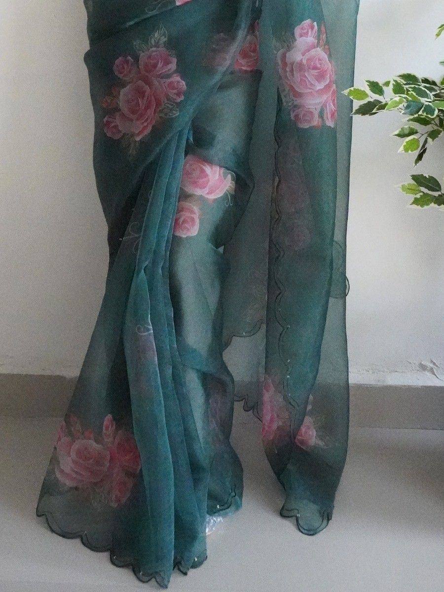Teal saree with pink rose print and scalloped border, ideal for ethnic occasions