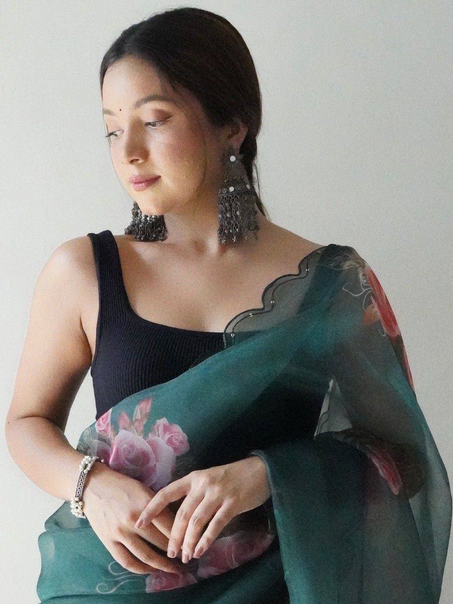 Woman in green floral saree with black blouse and statement earrings, ethnic Indian wear