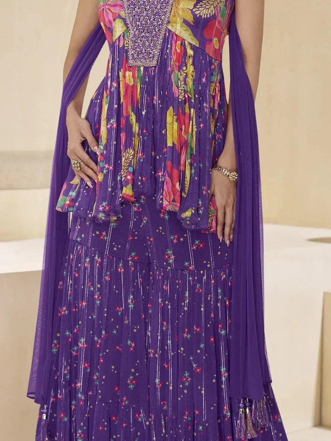 Purple floral printed ethnic gown with embroidered bodice and pleated skirt, perfect for festive occasions
