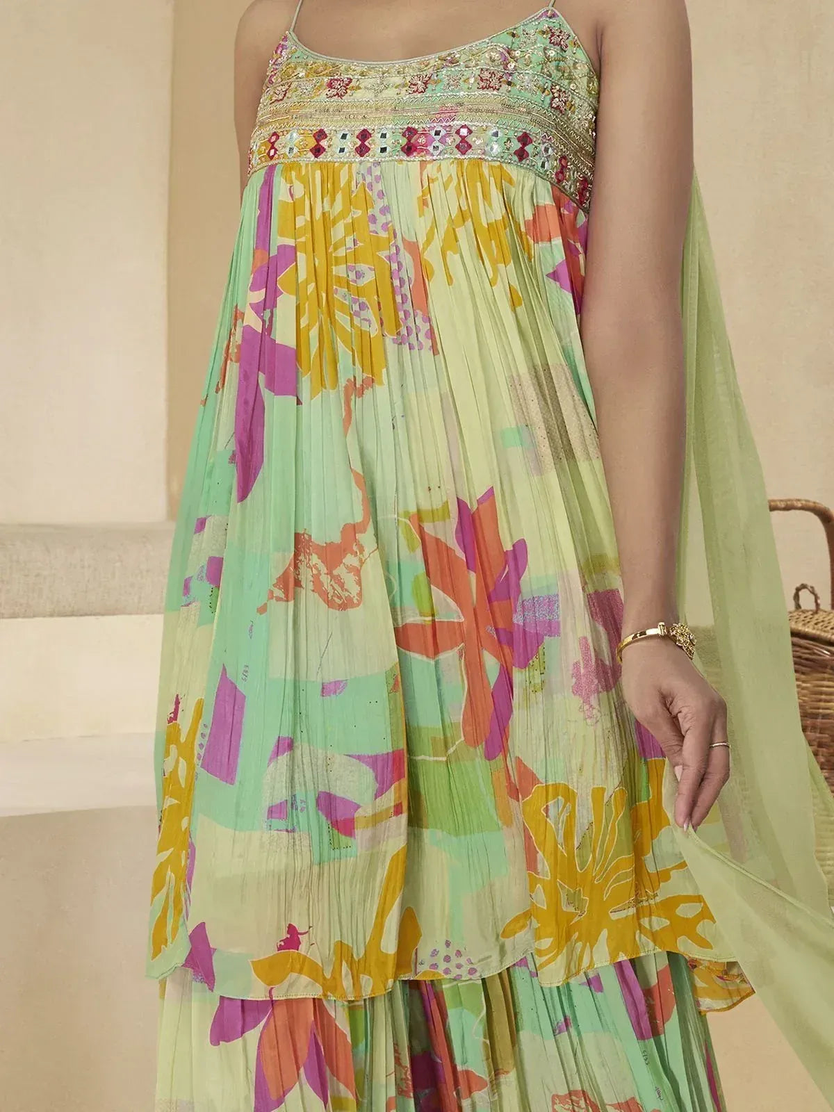 Colorful floral printed ethnic gown with embroidered neckline and pleated skirt