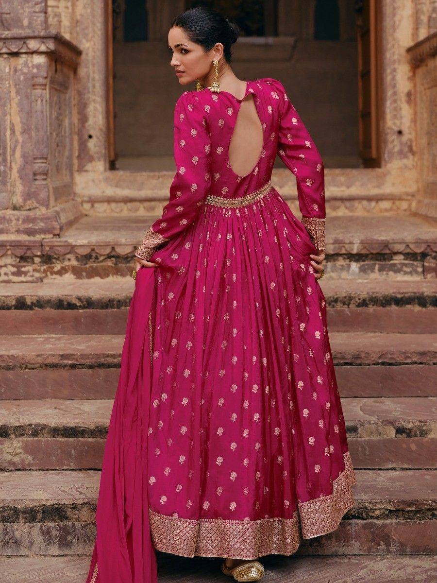 Pink designer anarkali with gold embroidery, back cutout, and pleated skirt, styled for ethnic occasions
