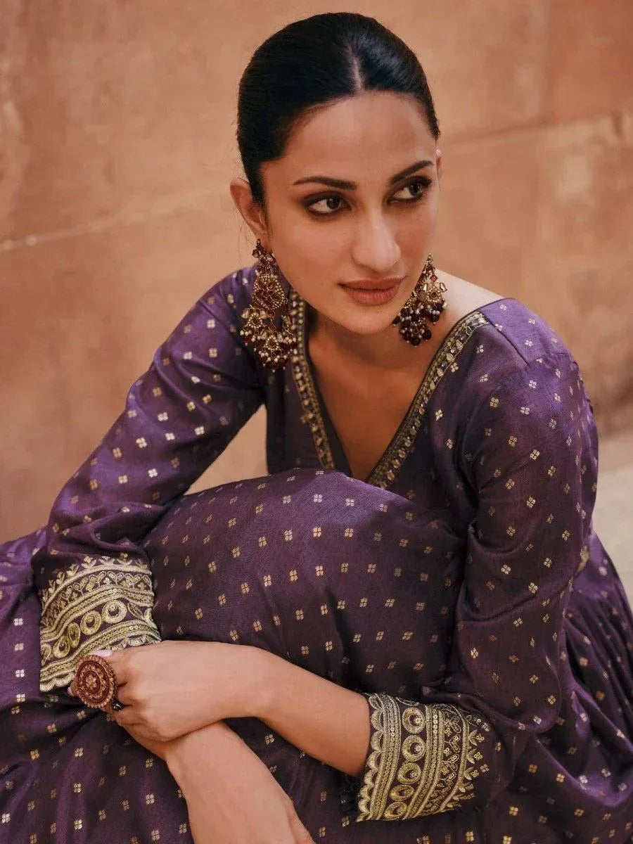 Purple ethnic gown with gold embroidery and traditional jewelry for Indian wear