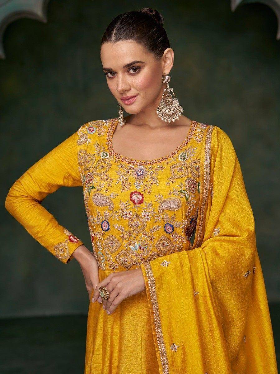 Yellow embroidered ethnic salwar kameez with floral motifs and gold detailing, perfect for festive occasions.