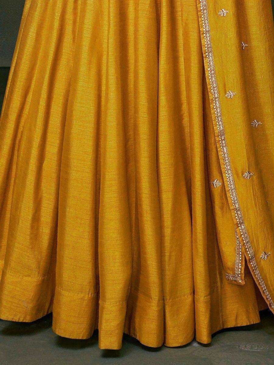 Mustard yellow lehenga choli with gold embroidery and floral motifs, ethnic Indian wear