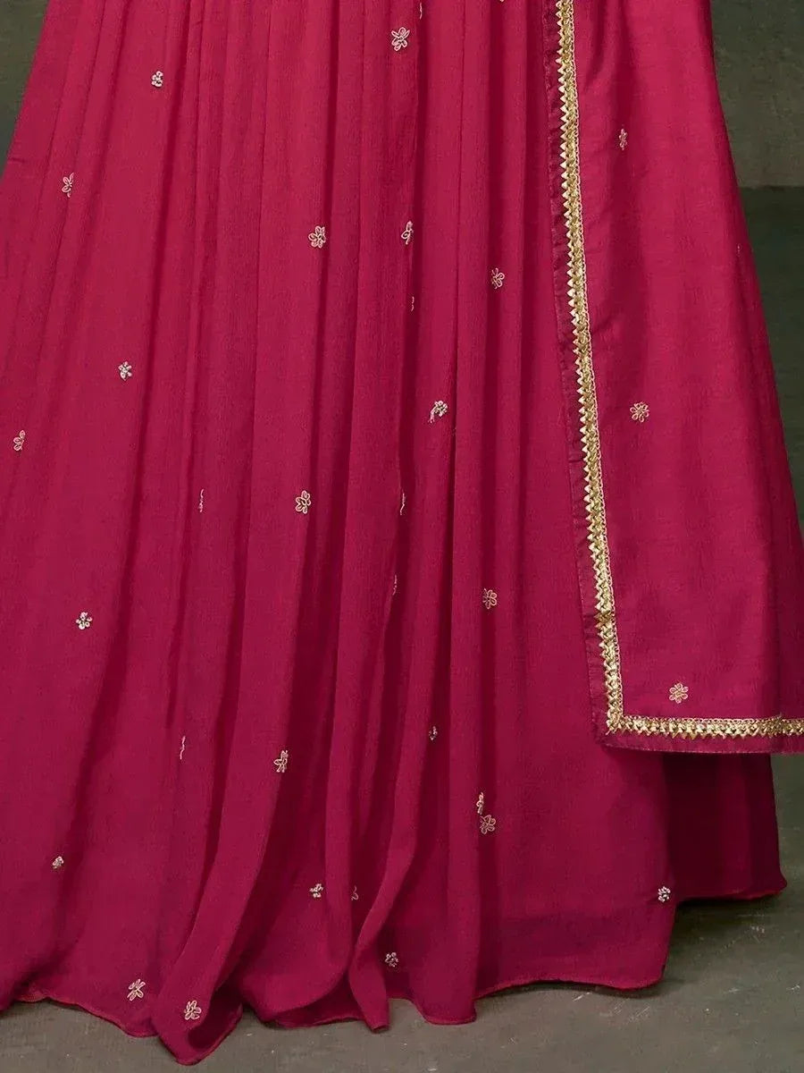 Deep pink ethnic gown with gold floral embroidery and border, ideal for Indian festive occasions
