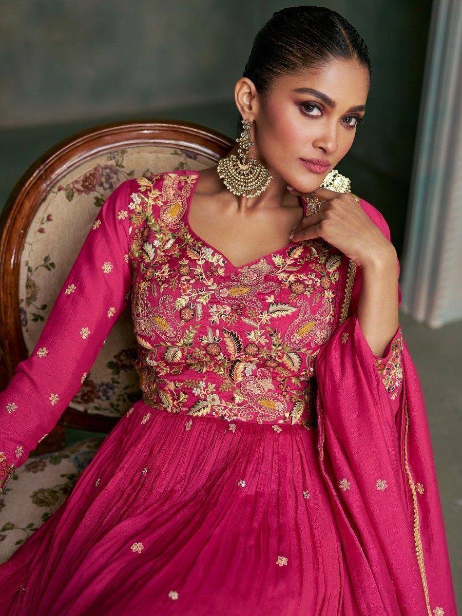 Pink embroidered ethnic gown with gold floral work, perfect for Indian weddings or festive occasions