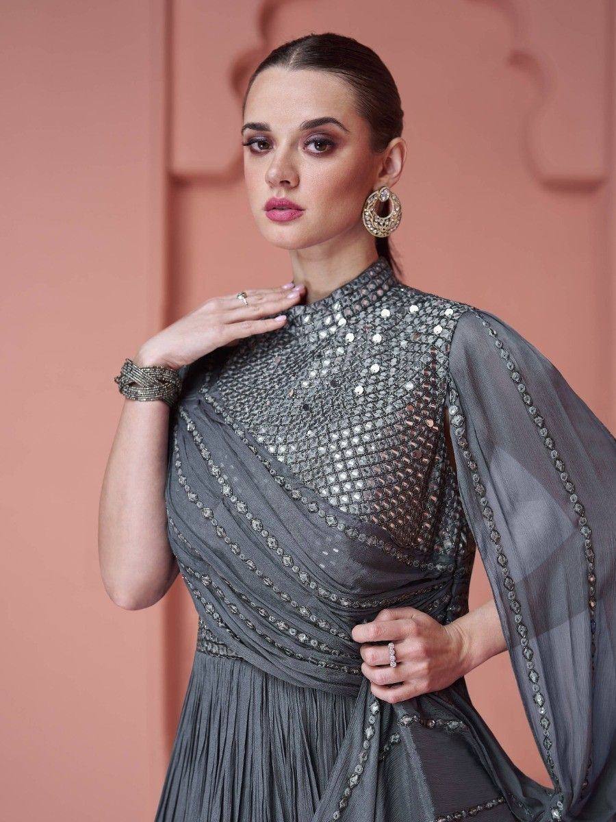 Woman in a grey embroidered ethnic gown with mirror work and statement earrings