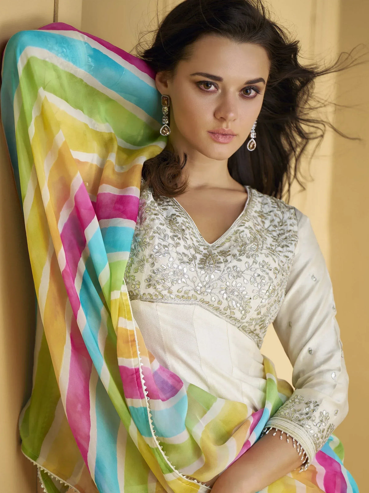 Elegant white embroidered salwar kameez with colorful striped dupatta, perfect for Indian ethnic wear.