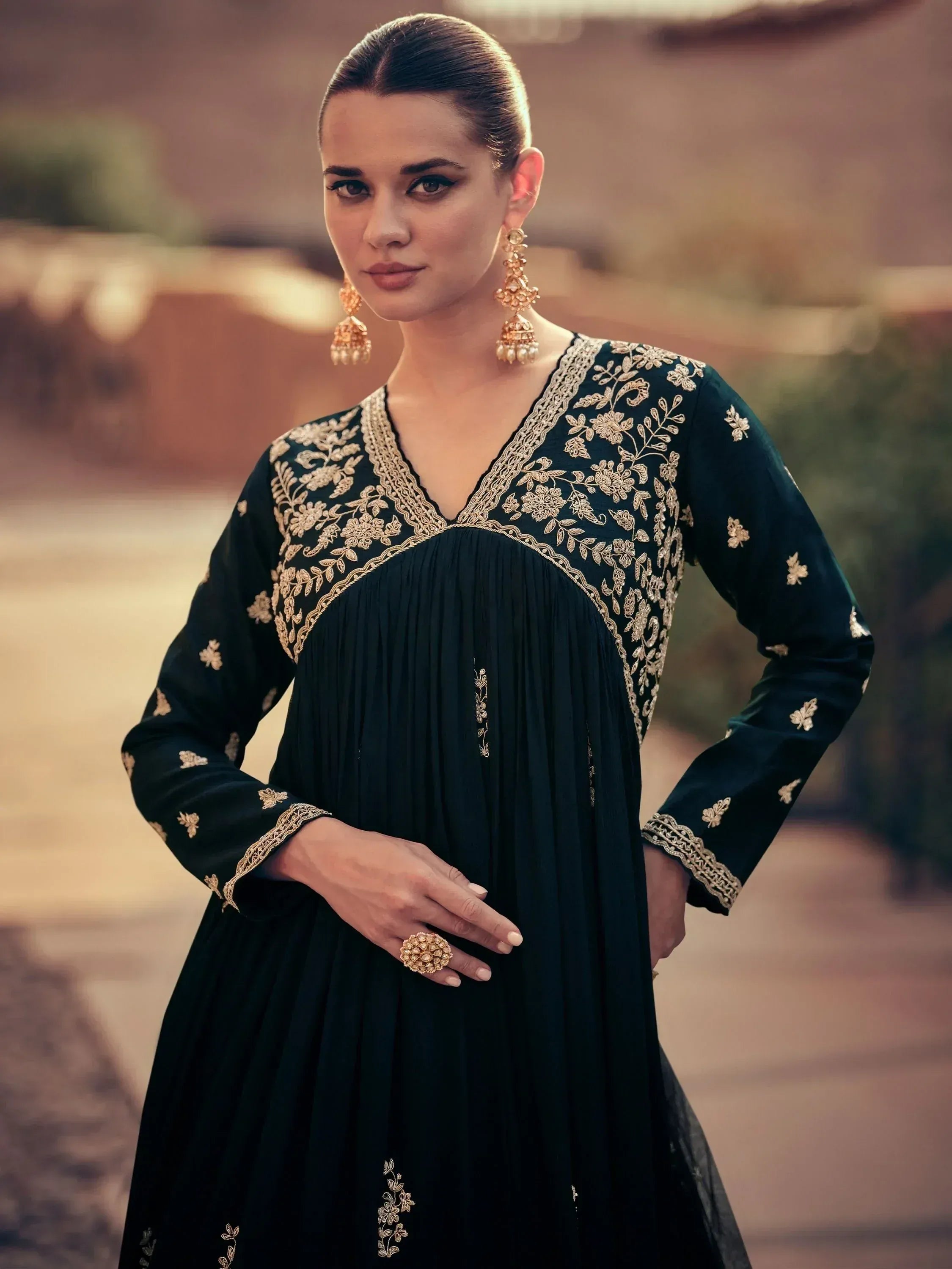 Elegant black ethnic gown with gold floral embroidery, perfect for Indian celebrations and festive occasions.