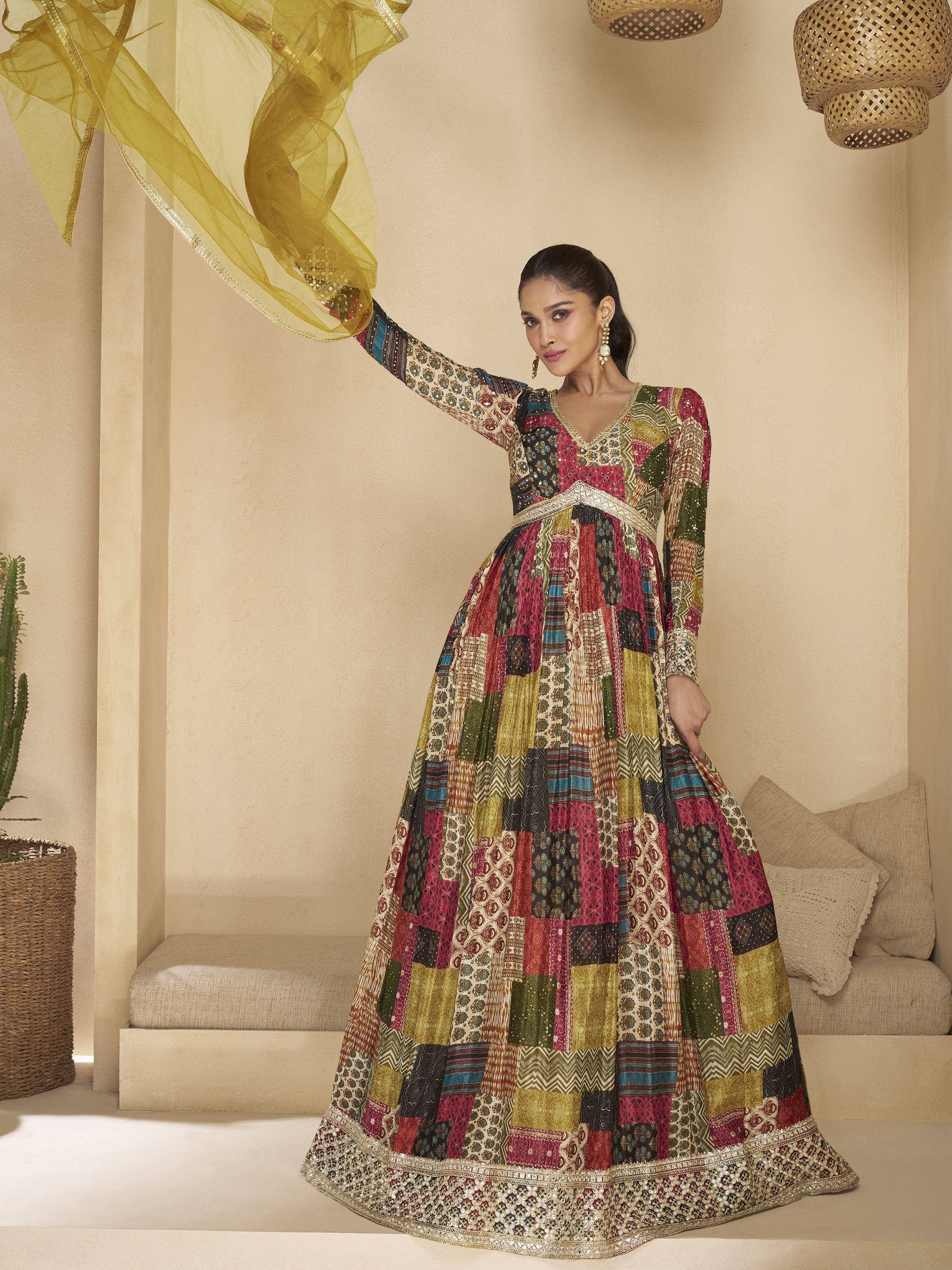 Woman in colorful patchwork ethnic gown with gold dupatta, perfect for Indian festive occasions