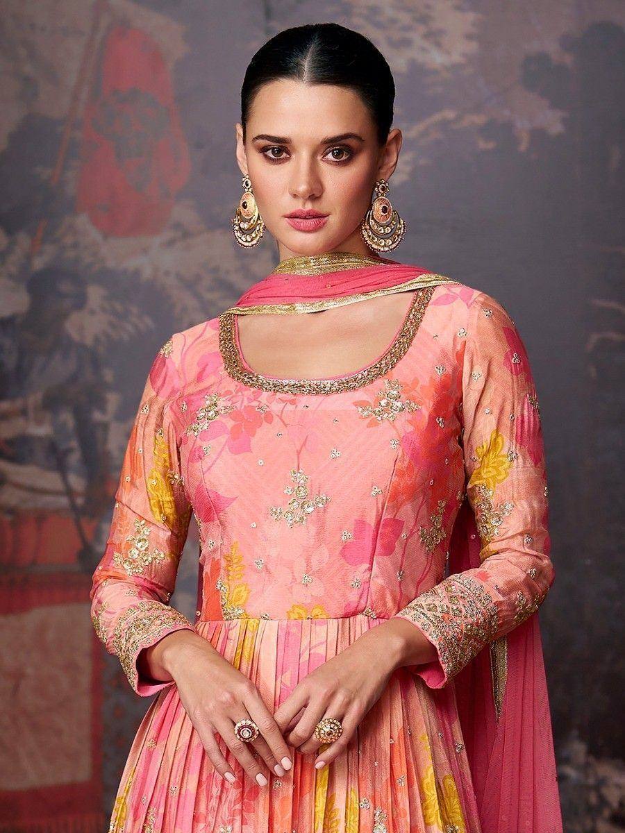 Pink floral embroidered salwar kameez with gold detailing and matching dupatta, styled with jhumka earrings