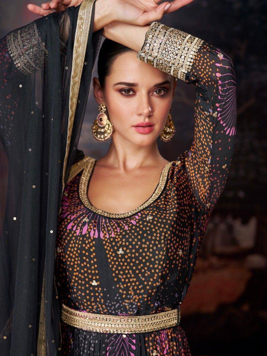 Black ethnic gown with gold embroidery, sequins, and pink motifs, paired with matching dupatta and statement earrings