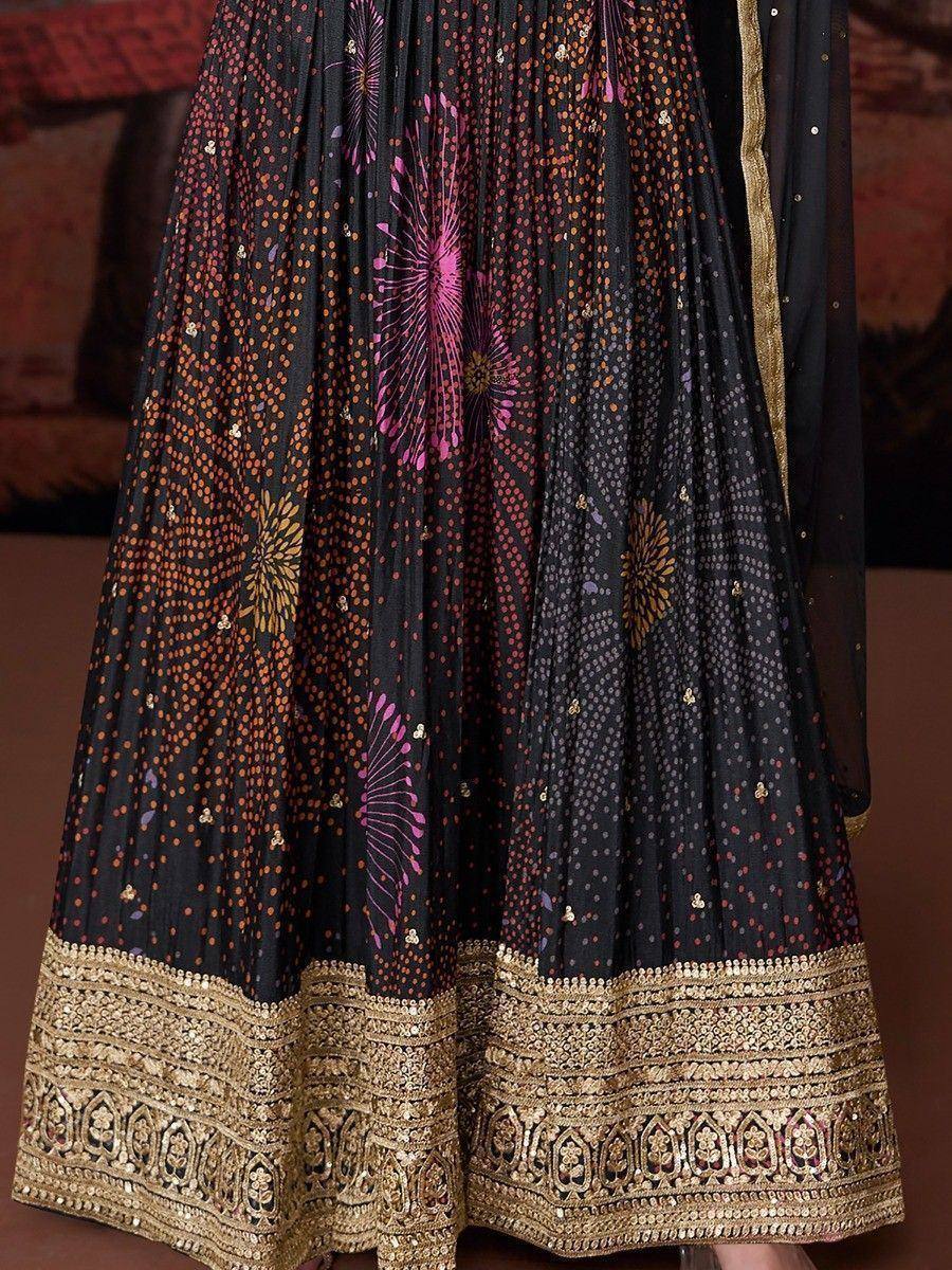 Black lehenga with pink and gold floral print, intricate border embroidery, ethnic wear