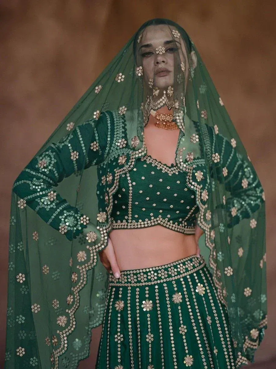 Emerald green designer lehenga choli with gold mirror work and sheer dupatta, perfect for Indian ethnic wear.