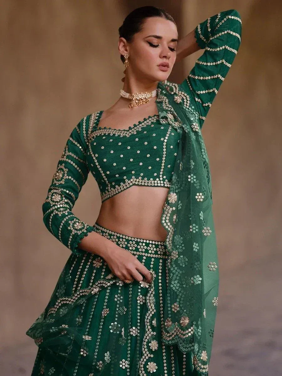 Emerald green designer lehenga choli with mirror work and floral embroidery, perfect for Indian ethnic wear.