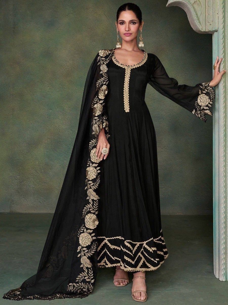Black ethnic gown with gold floral embroidery, long sleeves, and matching cape for women