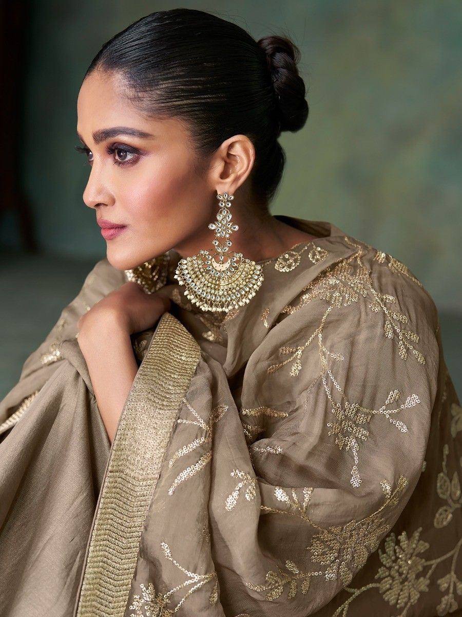 Elegant Indian ethnic wear with gold embroidery and statement jewelry