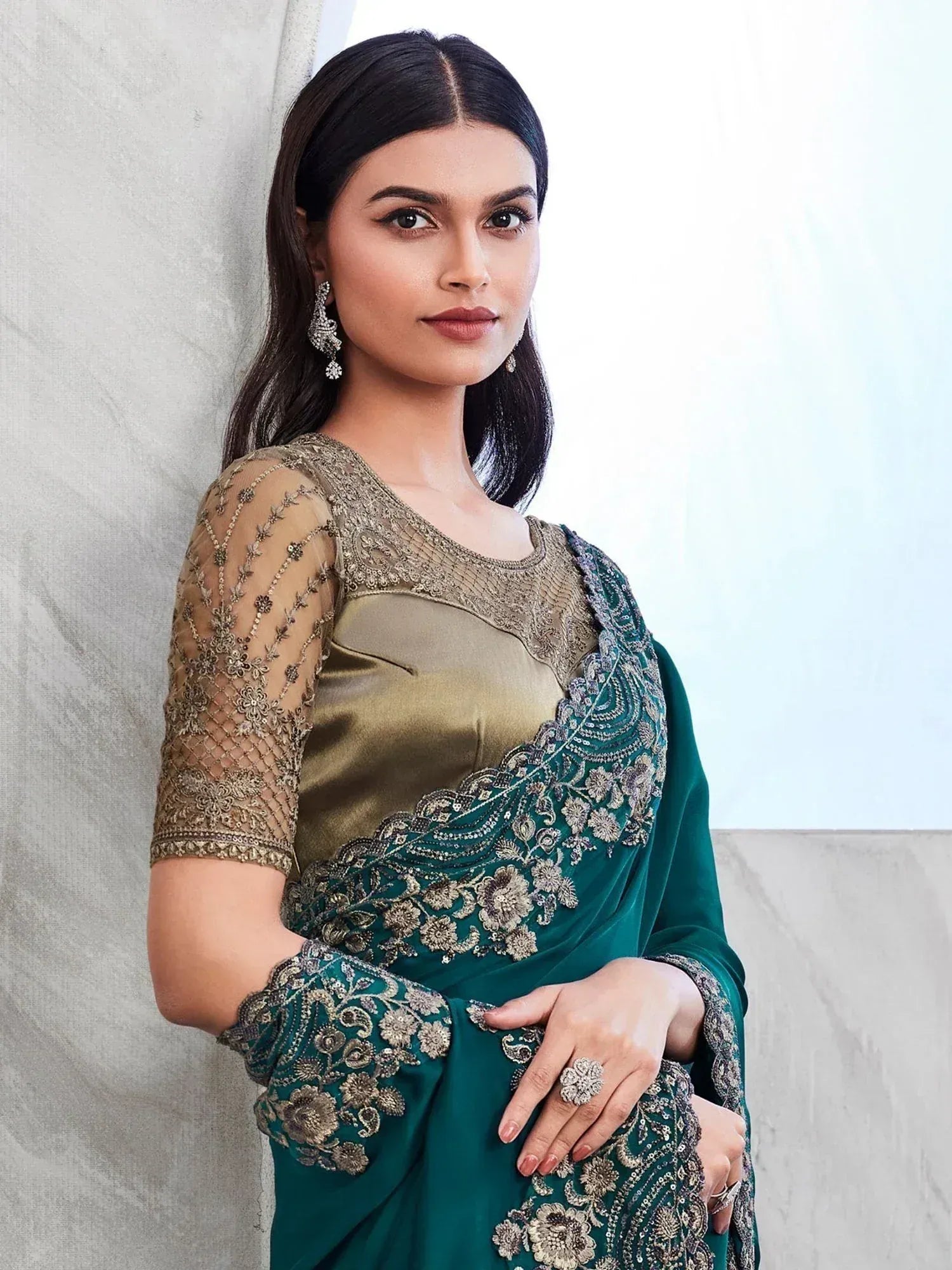 Elegant green and gold embroidered saree with sheer sleeves, perfect for Indian ethnic occasions.