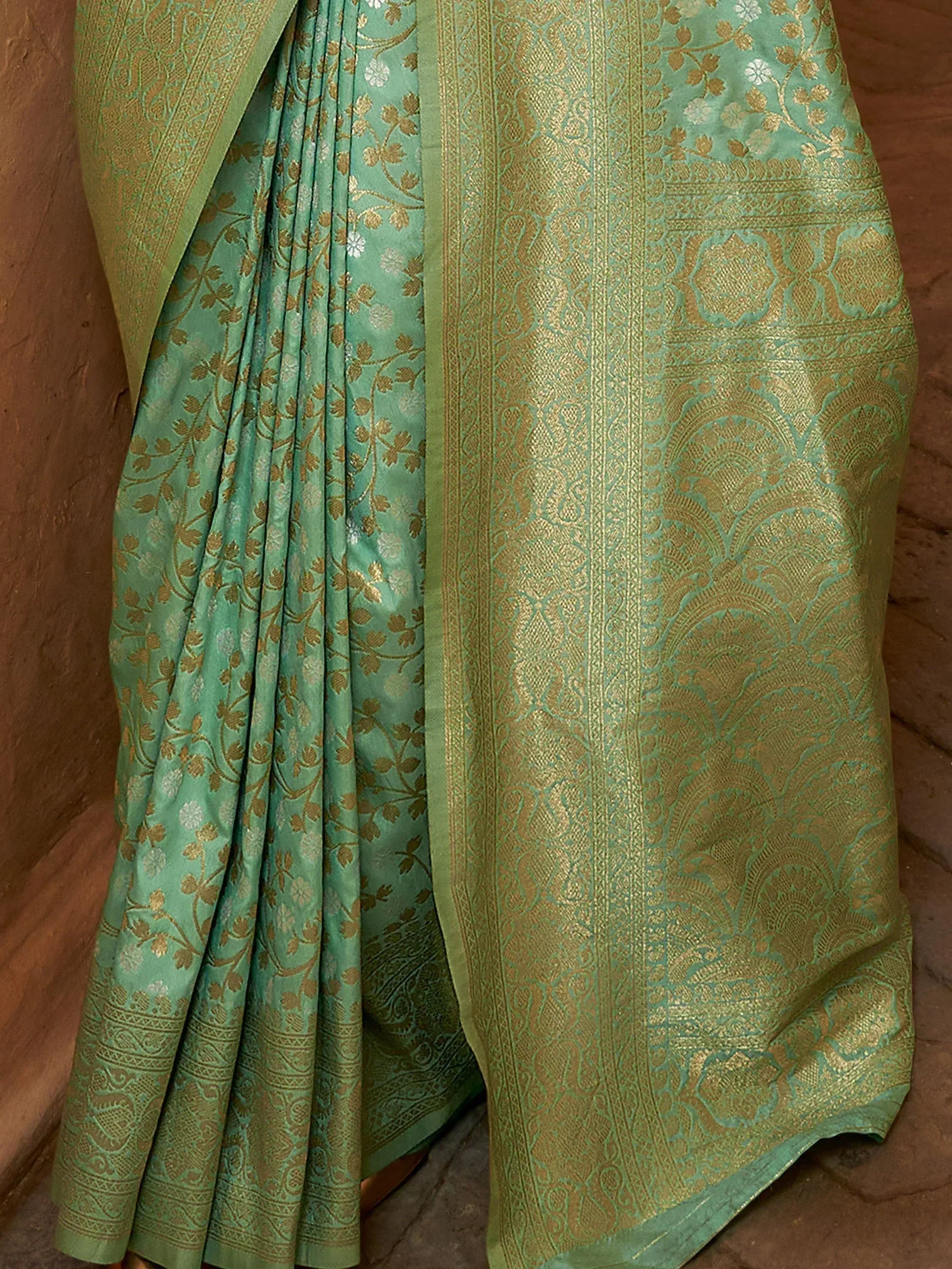 Mint green saree with gold floral and paisley brocade, perfect for Indian ethnic wear occasions