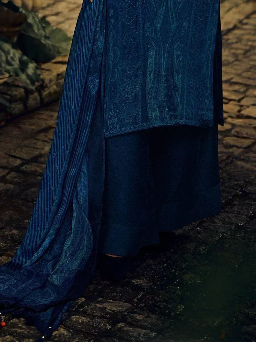 Blue ethnic salwar kameez with paisley print and striped dupatta on cobblestone