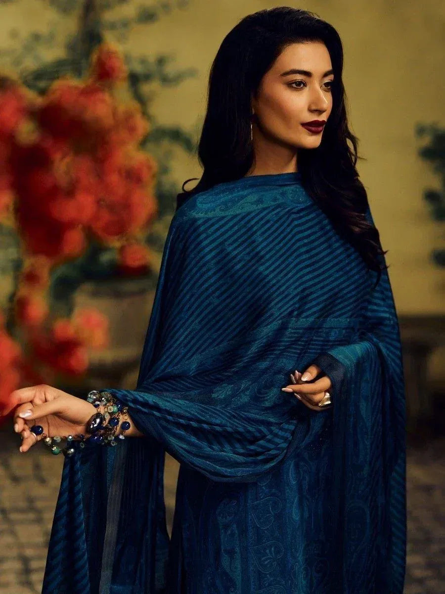 Elegant blue ethnic gown with paisley print, styled with statement jewelry for festive occasions