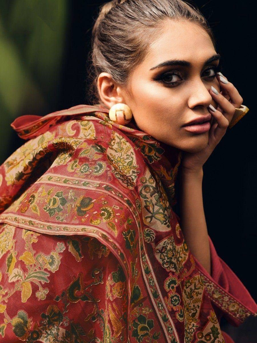 Elegant woman in floral ethnic saree with intricate patterns and bold makeup