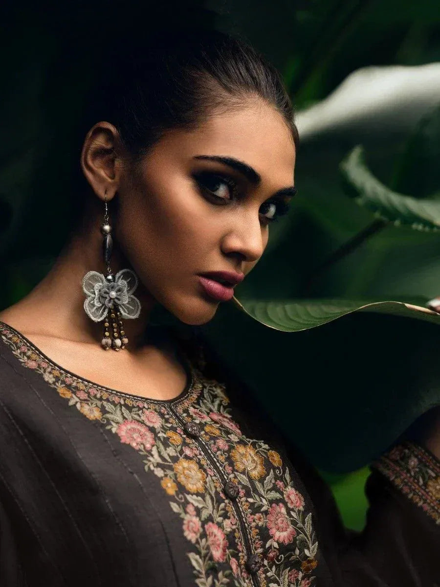Woman in embroidered ethnic kurti with floral design and statement earrings, styled for Indian wear