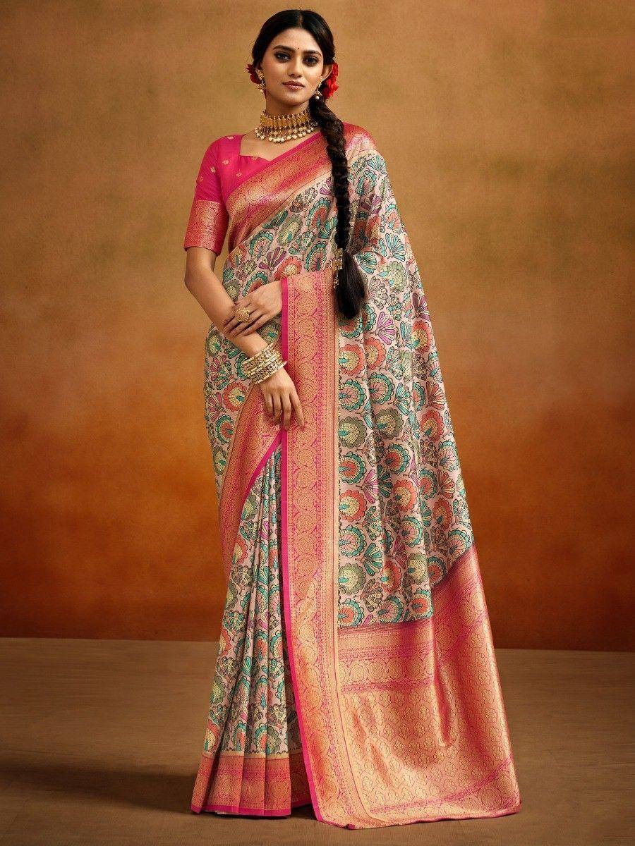 Woman in floral printed saree with pink blouse and gold jewelry, ethnic Indian wear