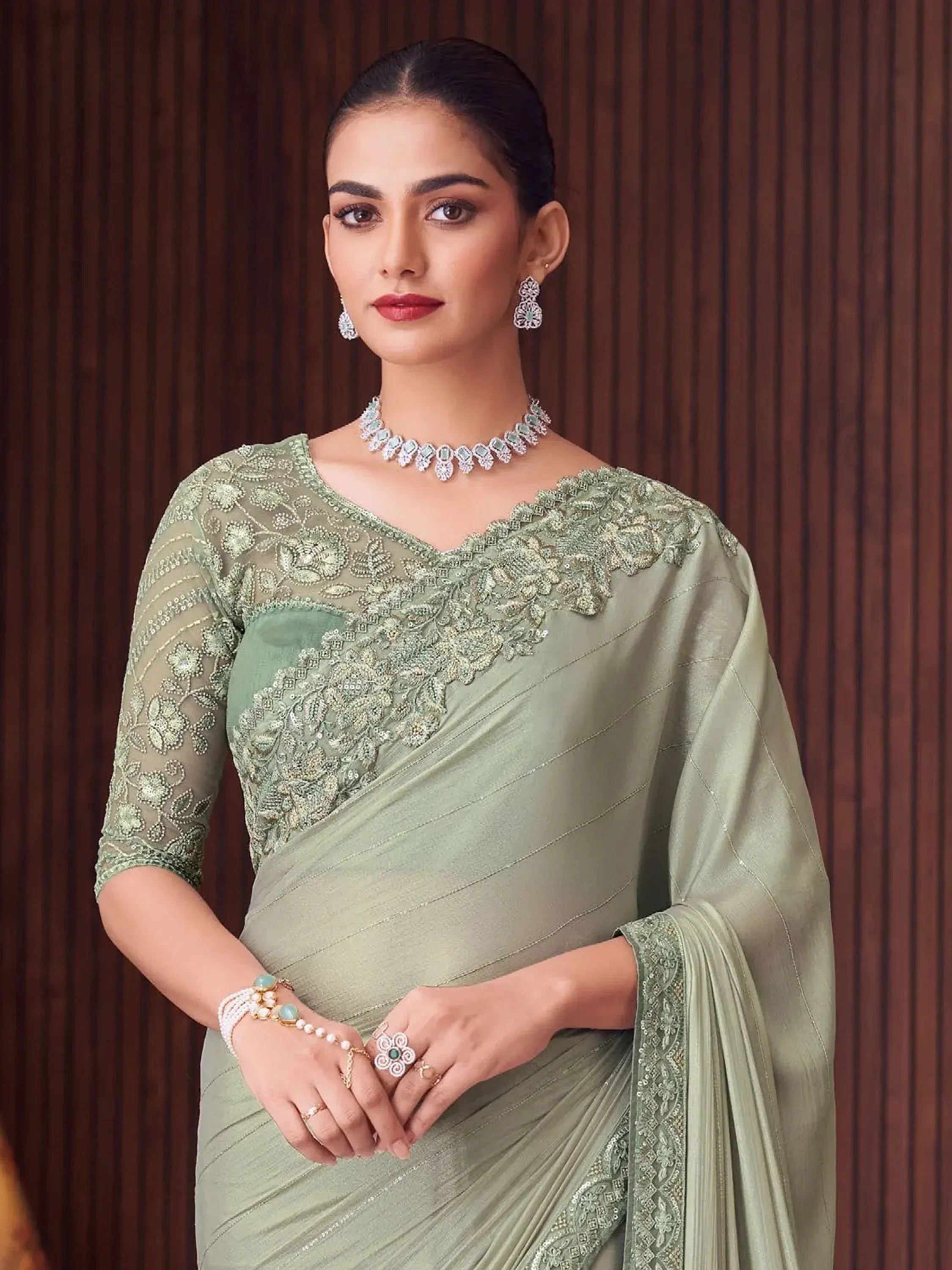 Elegant sage green saree with intricate floral embroidery and designer jewelry for Indian ethnic wear