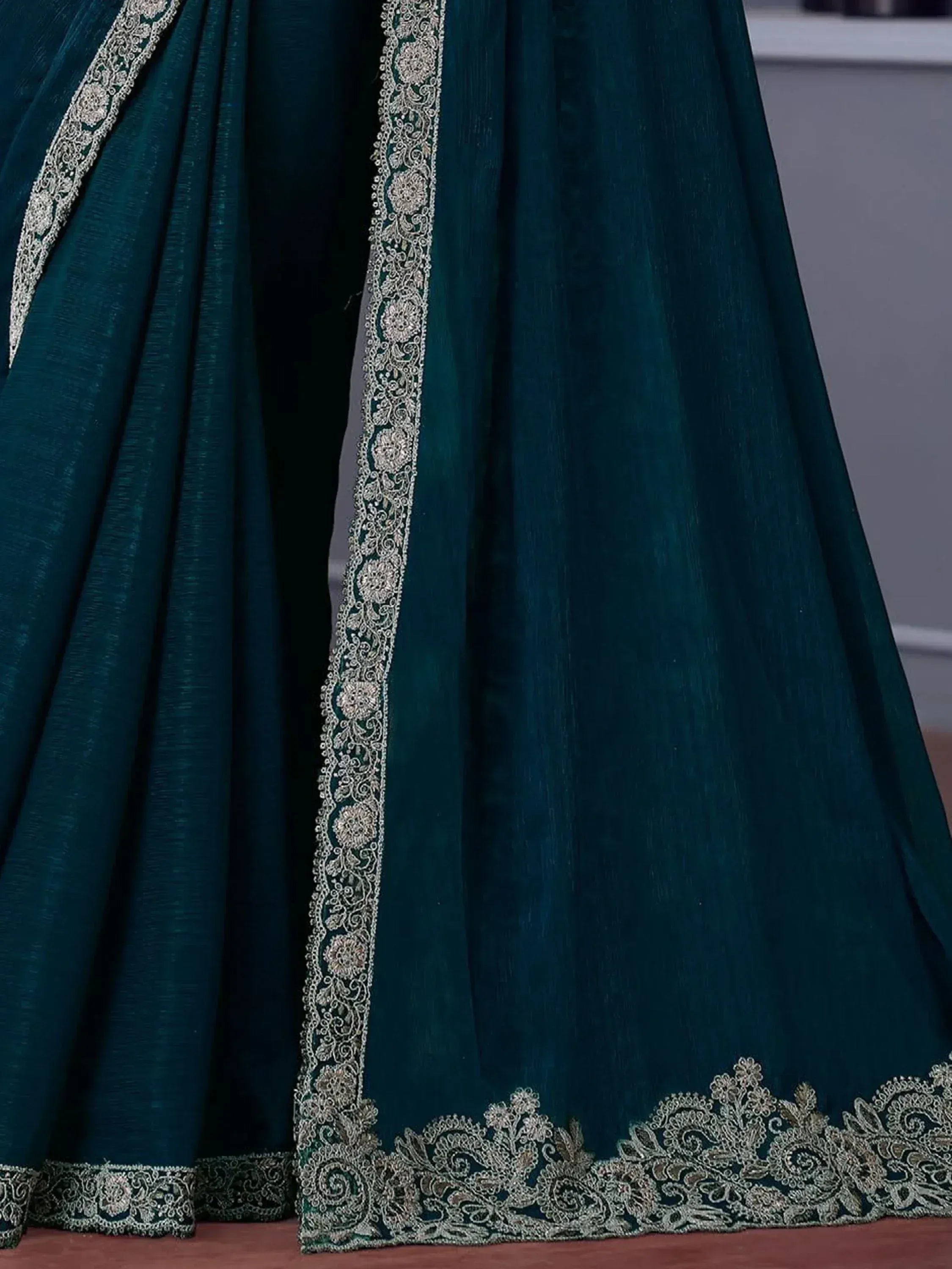 Emerald green ethnic gown with silver floral embroidery and lace detailing for festive occasions