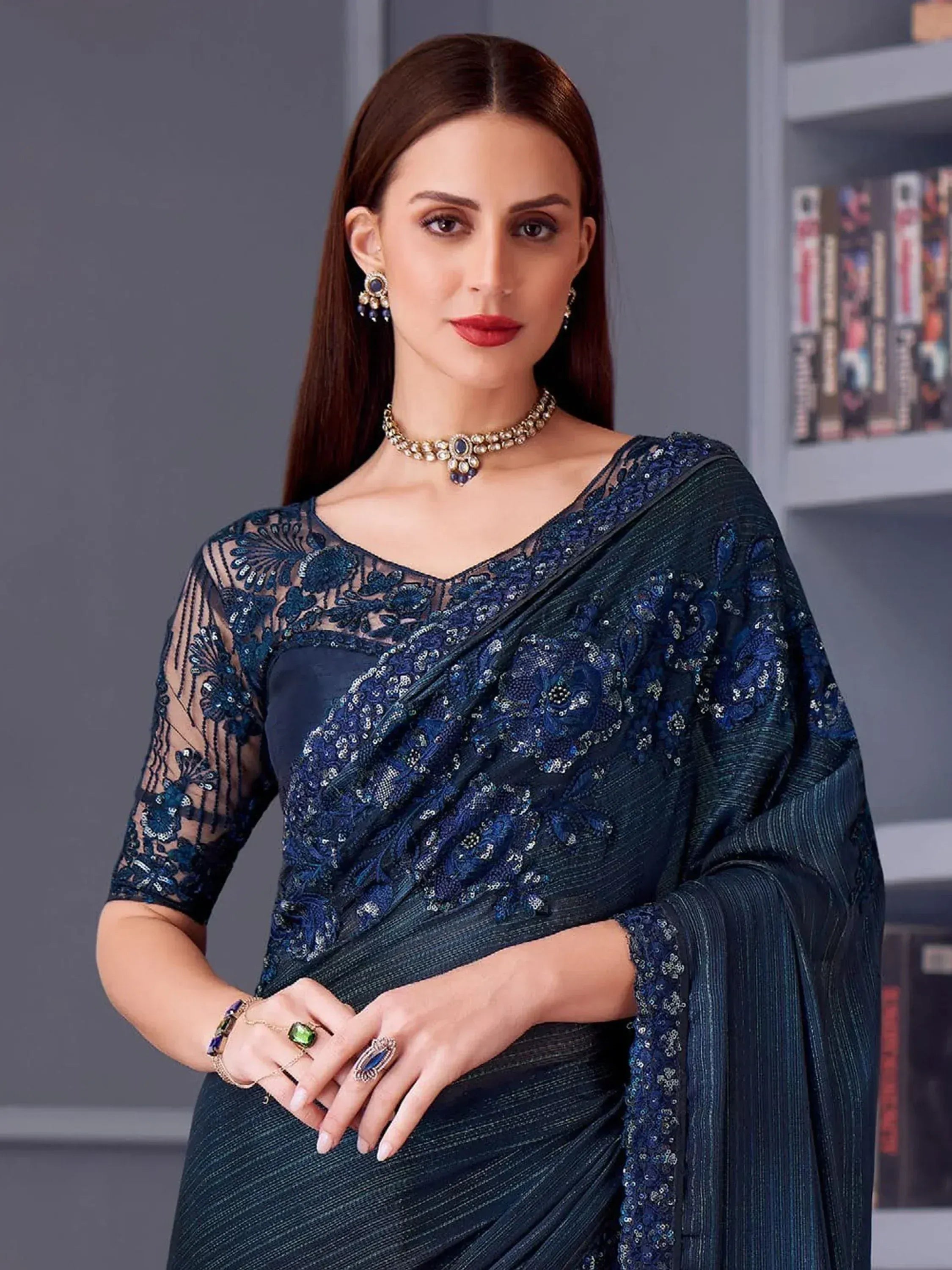 Elegant navy blue embroidered saree with sheer lace blouse, perfect for Indian ethnic occasions