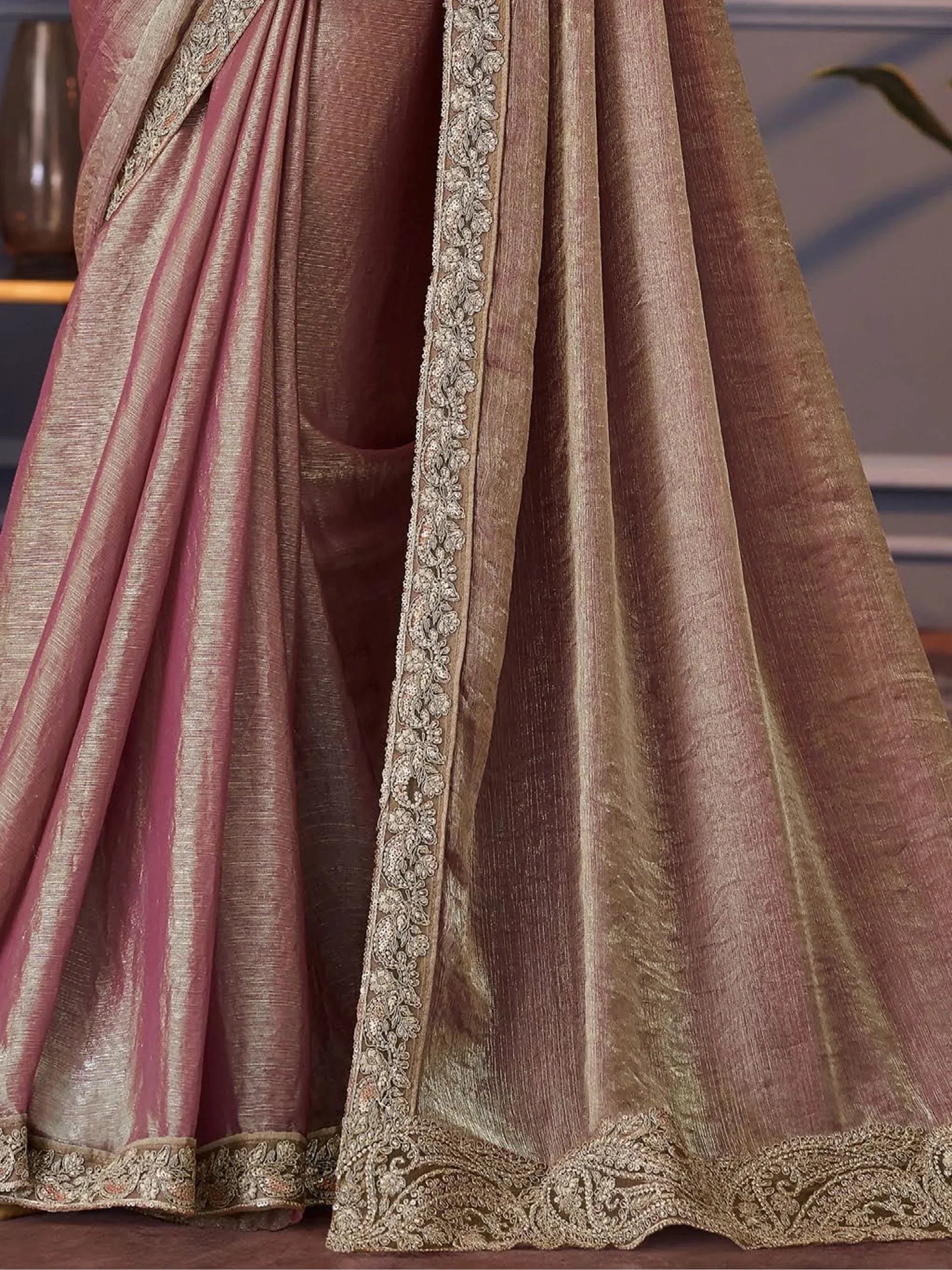 Elegant mauve and gold saree with intricate floral embroidery and shimmering texture, perfect for Indian ethnic occasions.