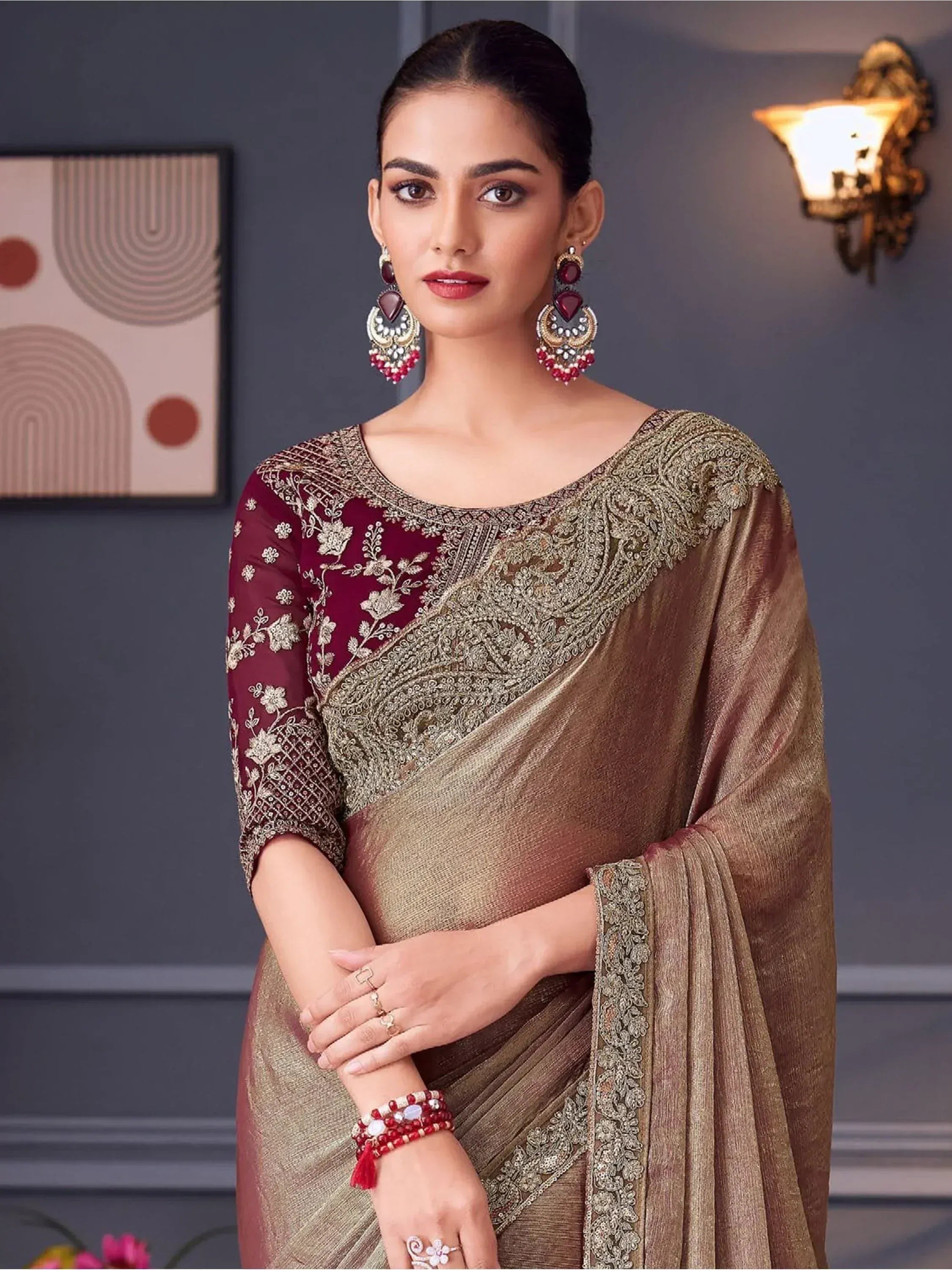 Elegant maroon and gold embroidered saree with designer blouse, perfect for Indian ethnic occasions