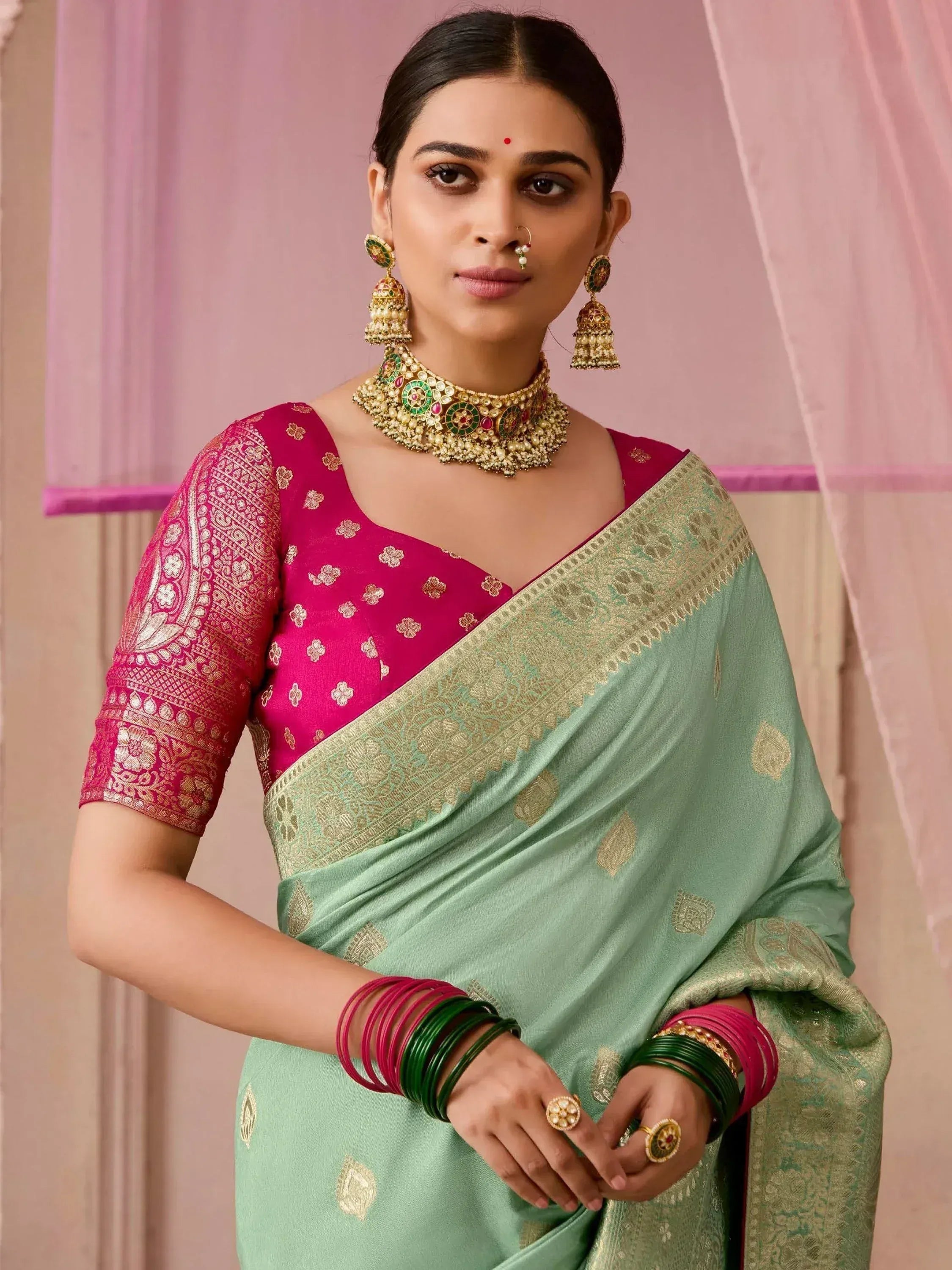Mint green saree with gold border and pink blouse, traditional Indian ethnic wear with jewelry