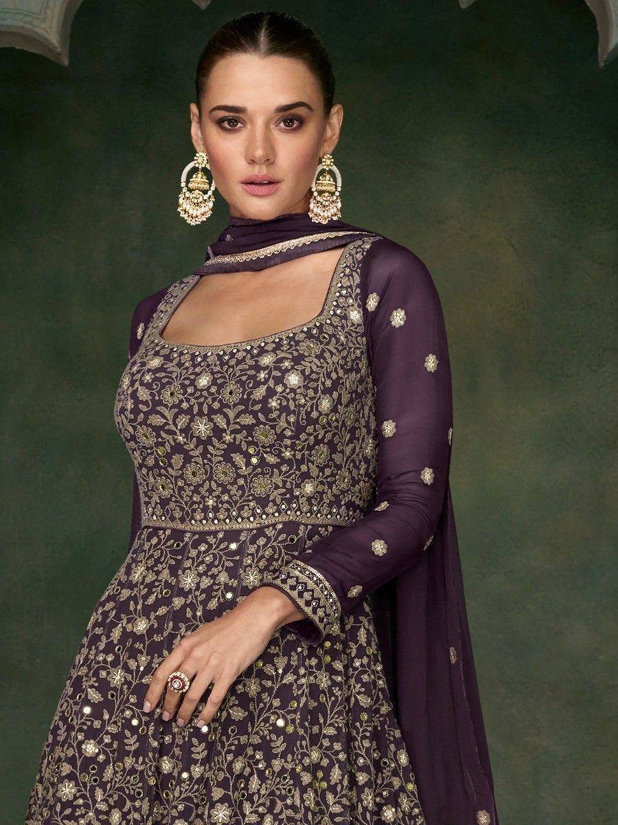 Purple embroidered anarkali suit with gold floral work, matching dupatta, and statement earrings for ethnic occasions
