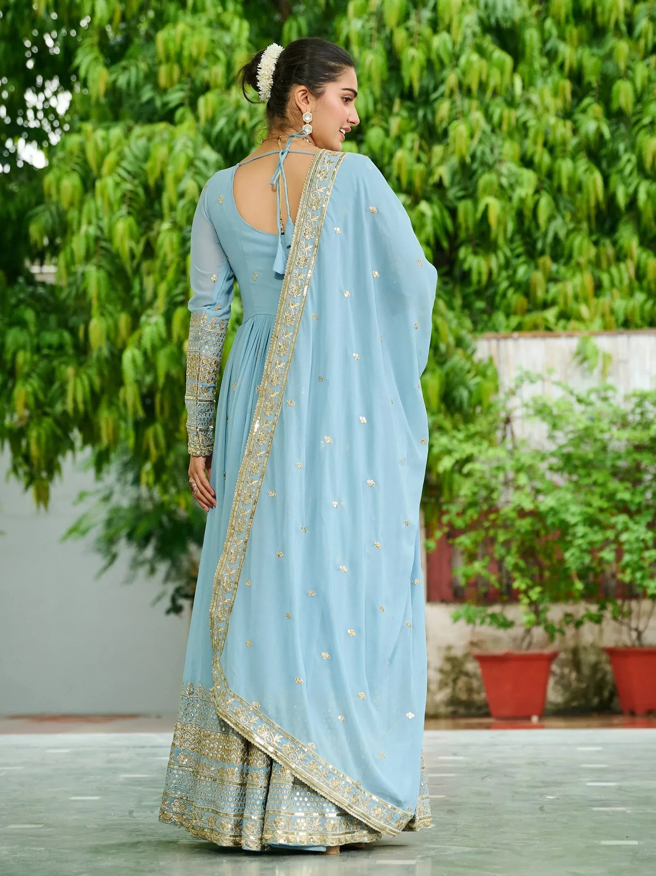 Light blue embroidered anarkali suit with gold detailing, perfect for Indian ethnic wear occasions.