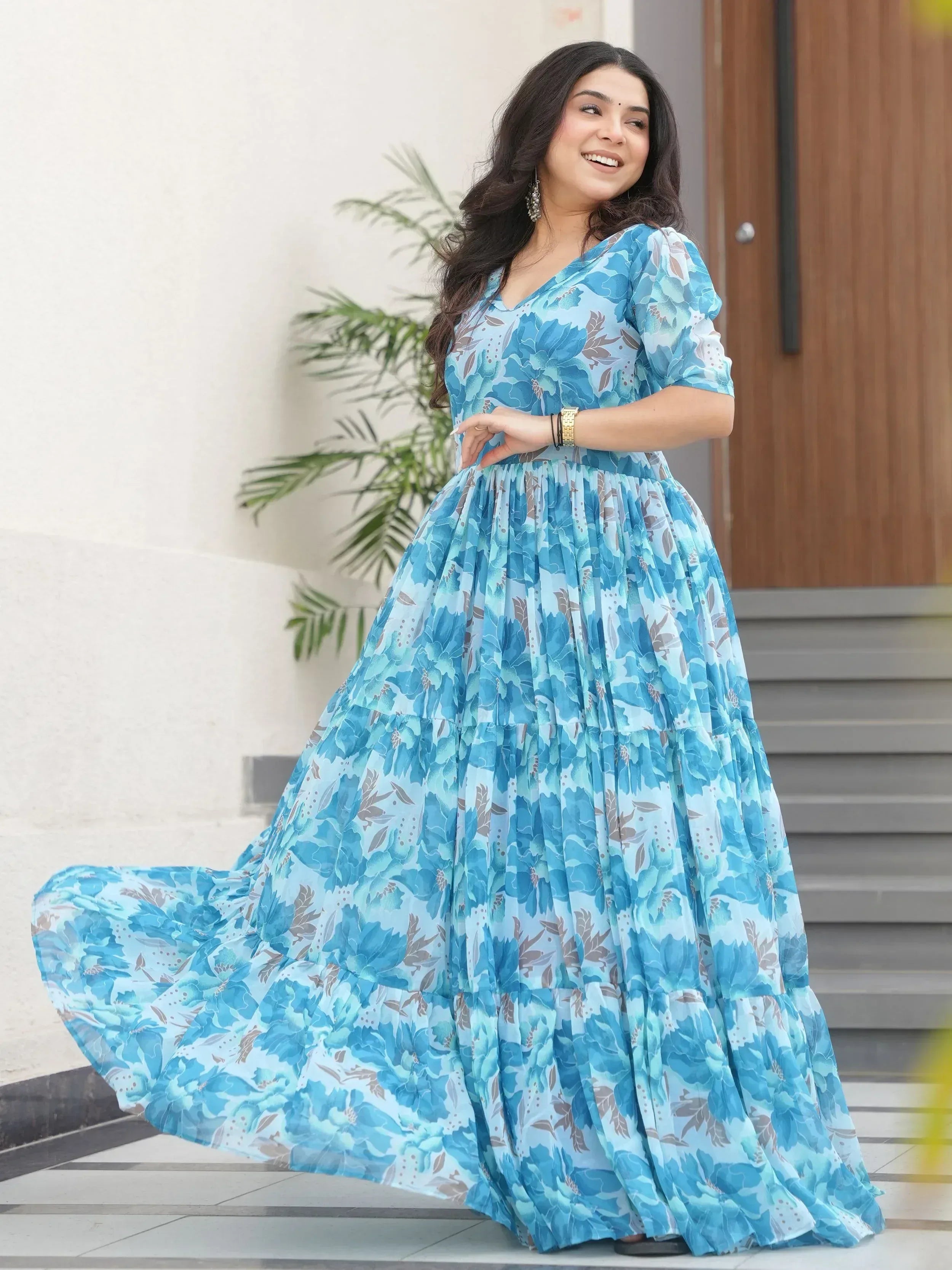 Blue floral ethnic gown with tiered skirt, perfect for Indian occasions and festive wear.