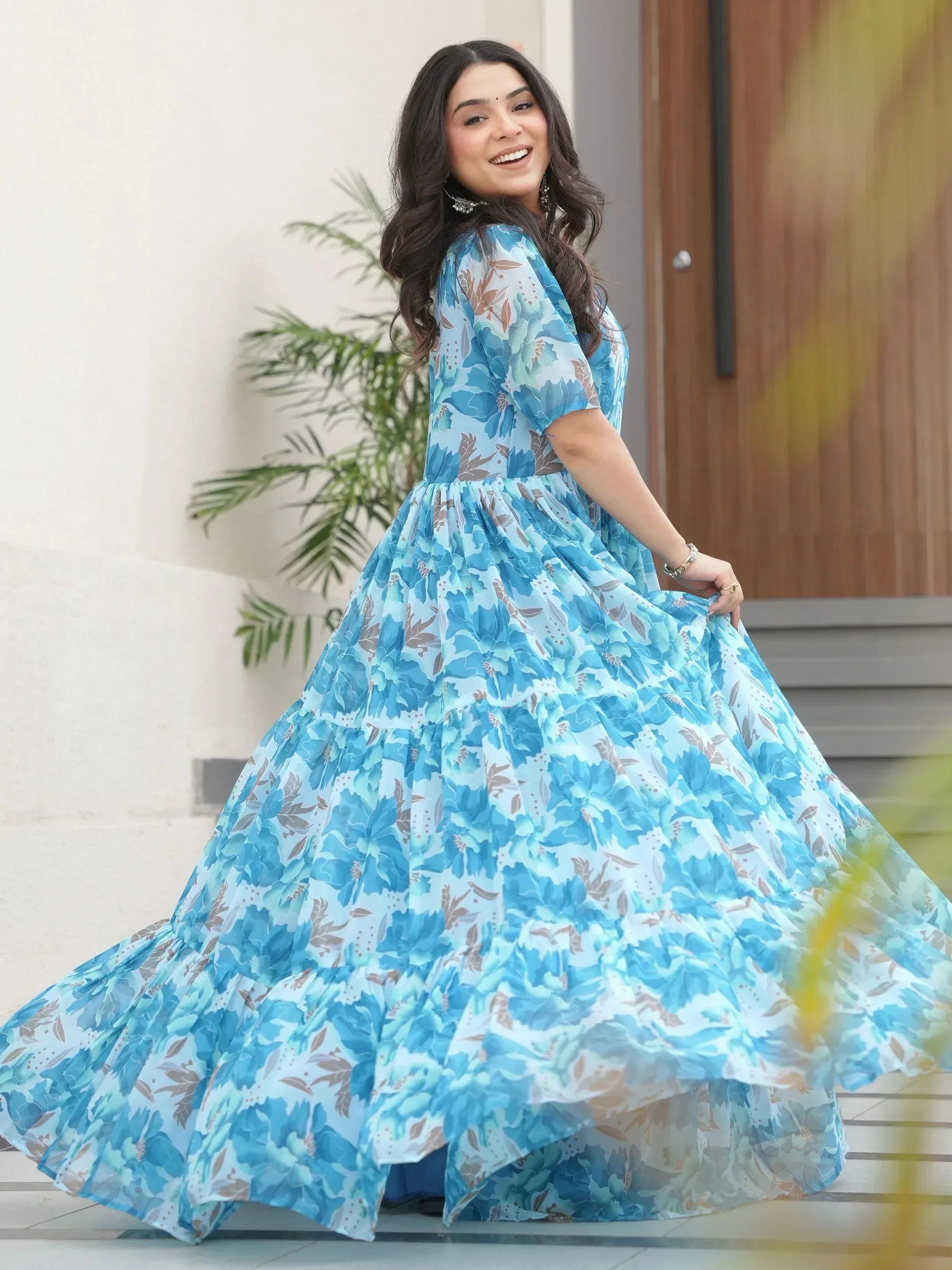 Blue floral ethnic gown with tiered skirt, perfect for Indian occasions and festive wear.