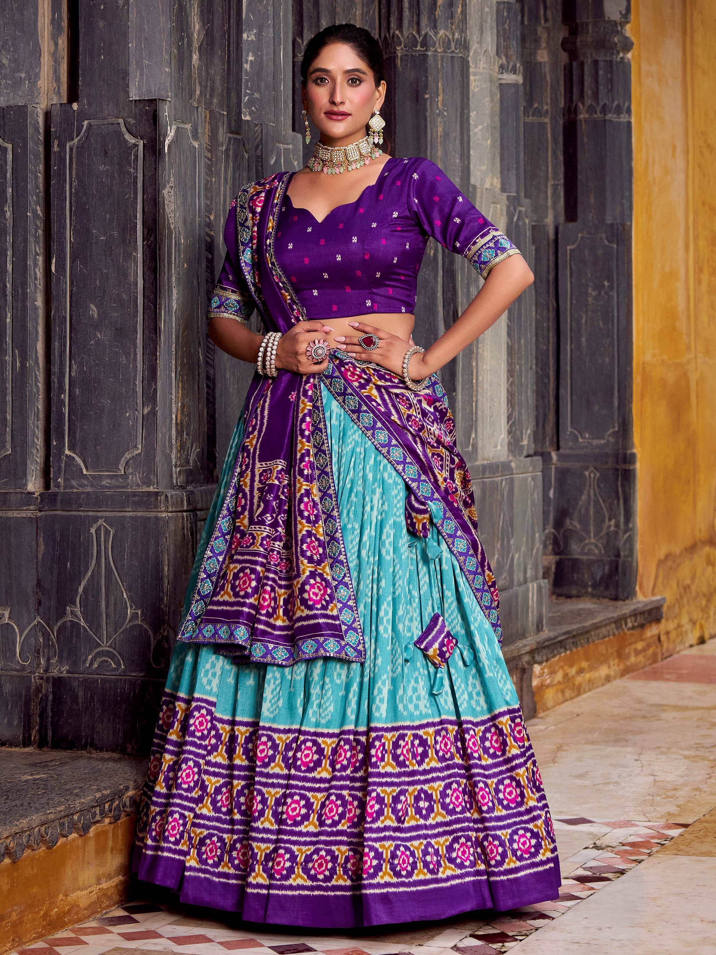 Purple and turquoise designer lehenga choli with intricate ikat print, perfect for Indian ethnic wear occasions.