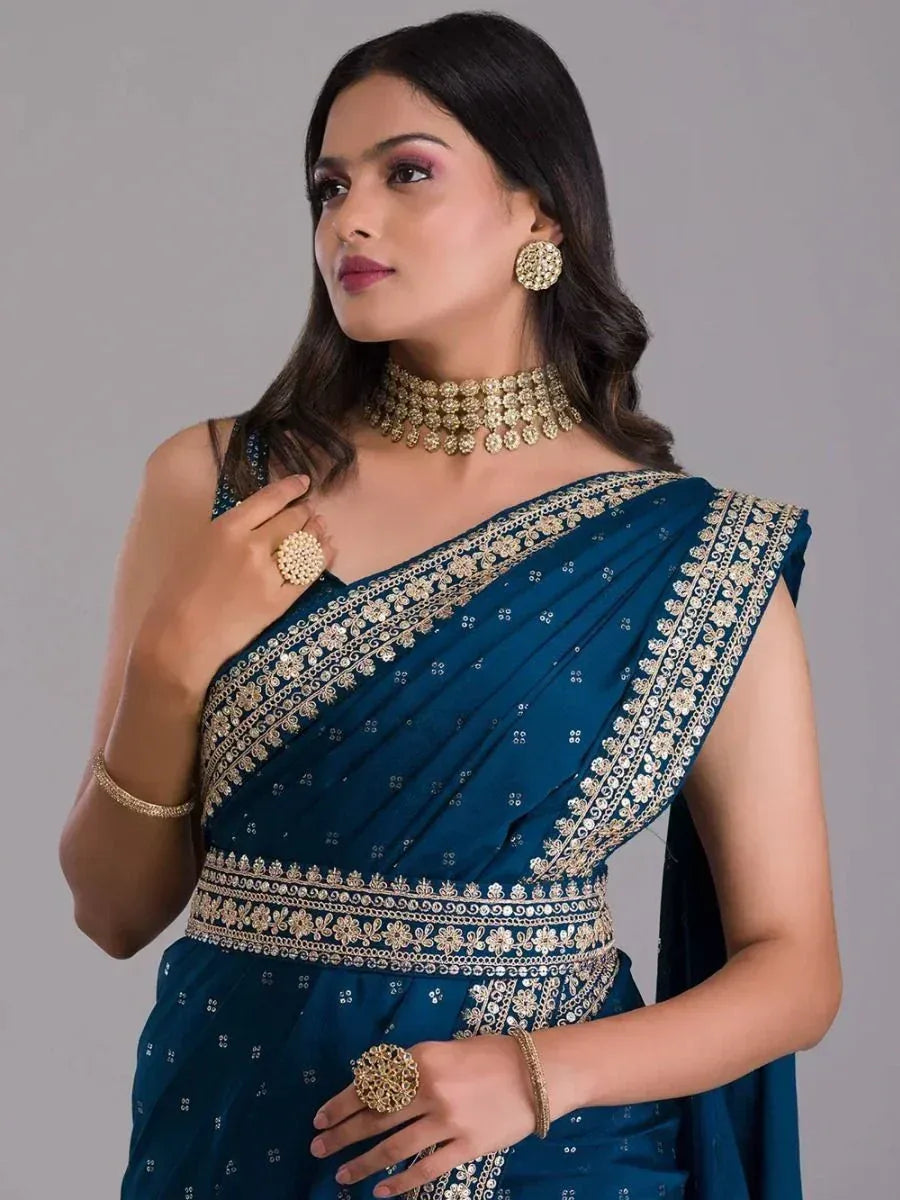 Teal blue designer saree with gold embroidery, perfect for Indian ethnic wear and festive occasions.