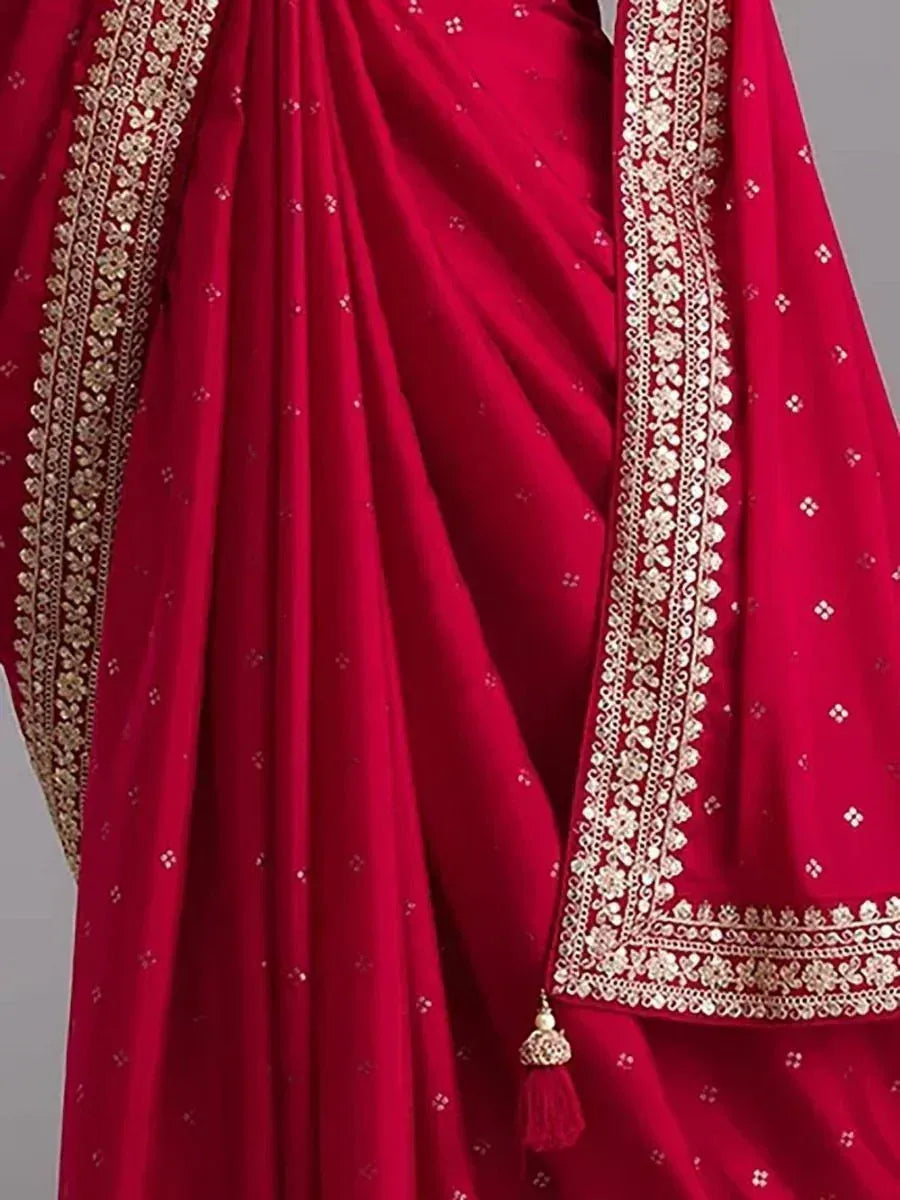 Red ethnic saree with gold floral embroidery and tassel detail, perfect for Indian occasions