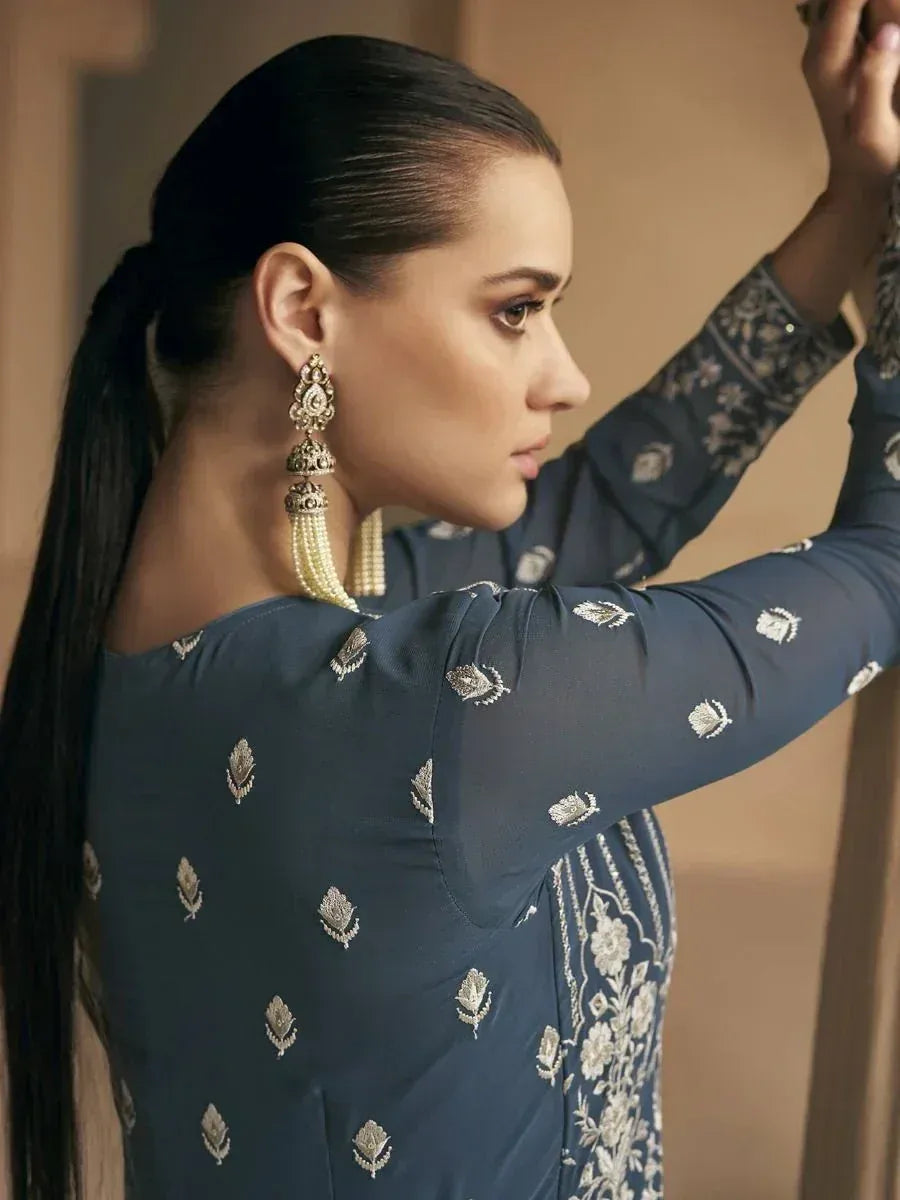 Woman in navy blue embroidered salwar kameez with pearl jhumka earrings, ethnic Indian wear