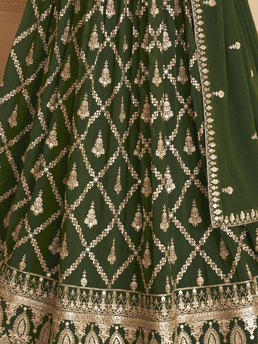 Emerald green lehenga with intricate gold embroidery and mirror work, perfect for Indian ethnic occasions.