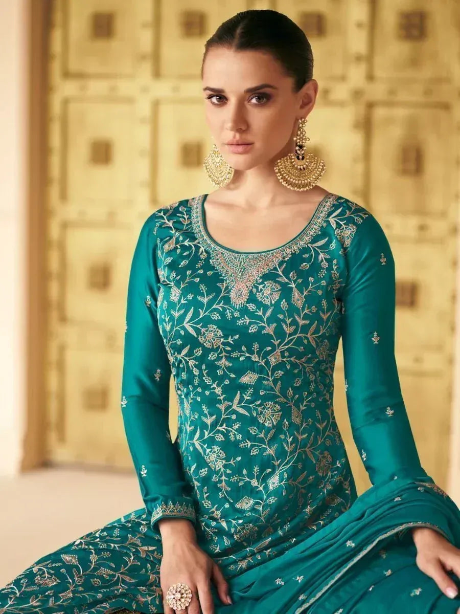 Teal embroidered salwar kameez with gold floral work, perfect for Indian ethnic wear occasions.